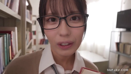 眼镜 · 站立 · 微笑 · 面部特写 · 对视 · 针织衫 · 图书馆 · 教师