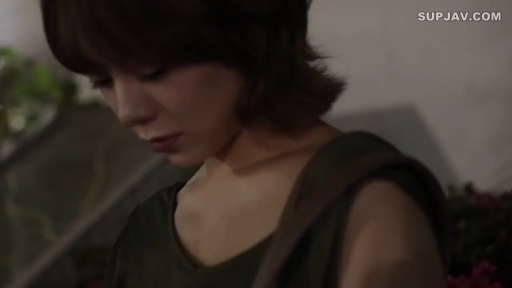 昏暗环境 · 平静 · 向下看 · 微侧身 · 网站水印 · 深绿色背心 · 单肩包背带 · 中近景特写