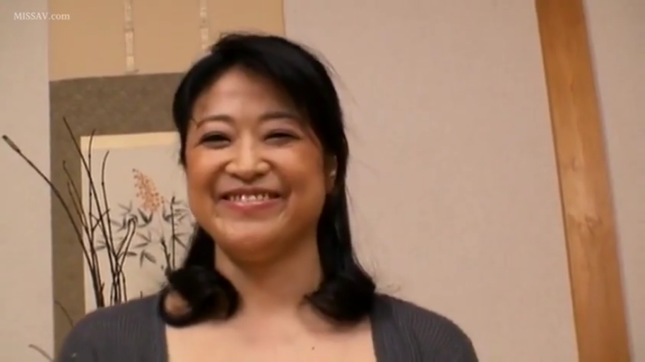 室内 · 微笑 · 面对镜头 · 面部特写 · 熟女 · 灰色针织衫 · 正面坐姿 · 背景装饰画